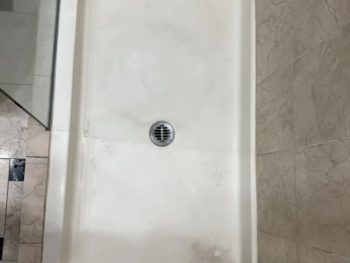 Worn shower before refinishing in Los Angeles