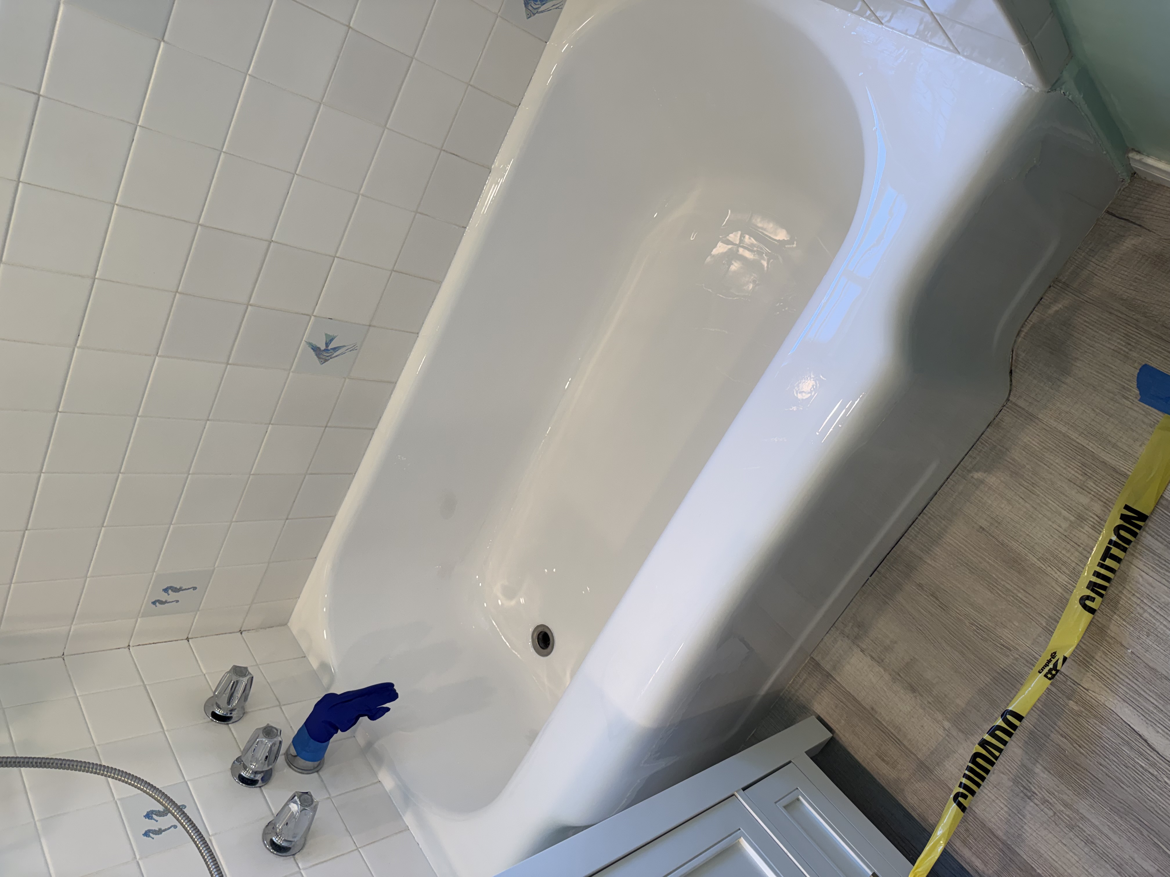 Refinished glossy white cast iron bathtub