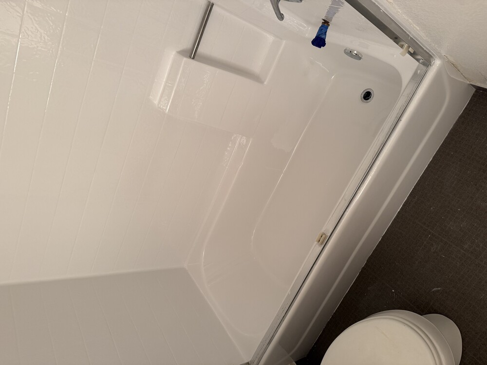 Fully restored one-piece plastic tub and shower unit