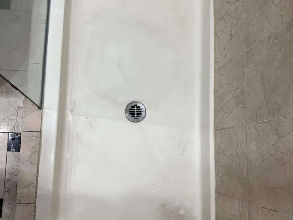 Worn shower before refinishing in Los Angeles