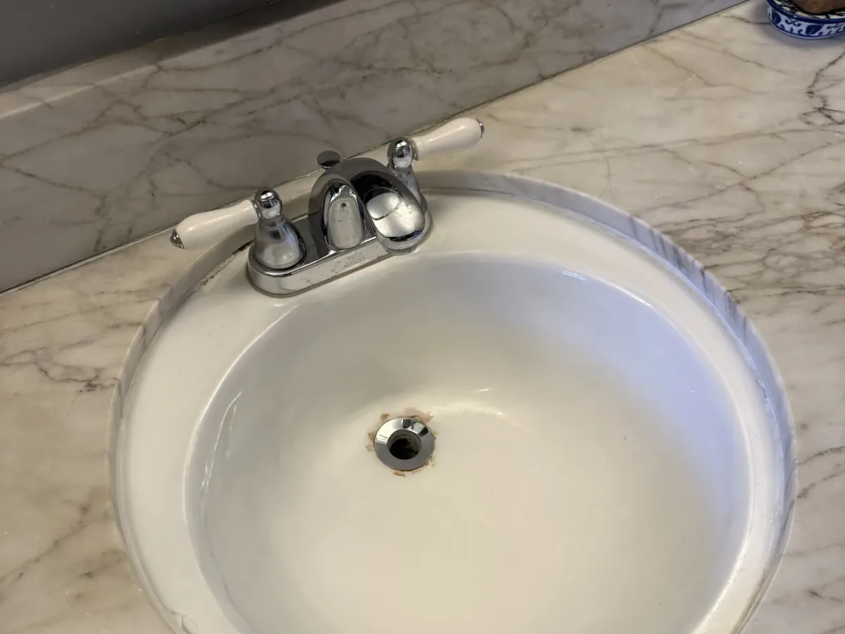 Round bathroom vanity sink after professional refinishing in Los Angeles