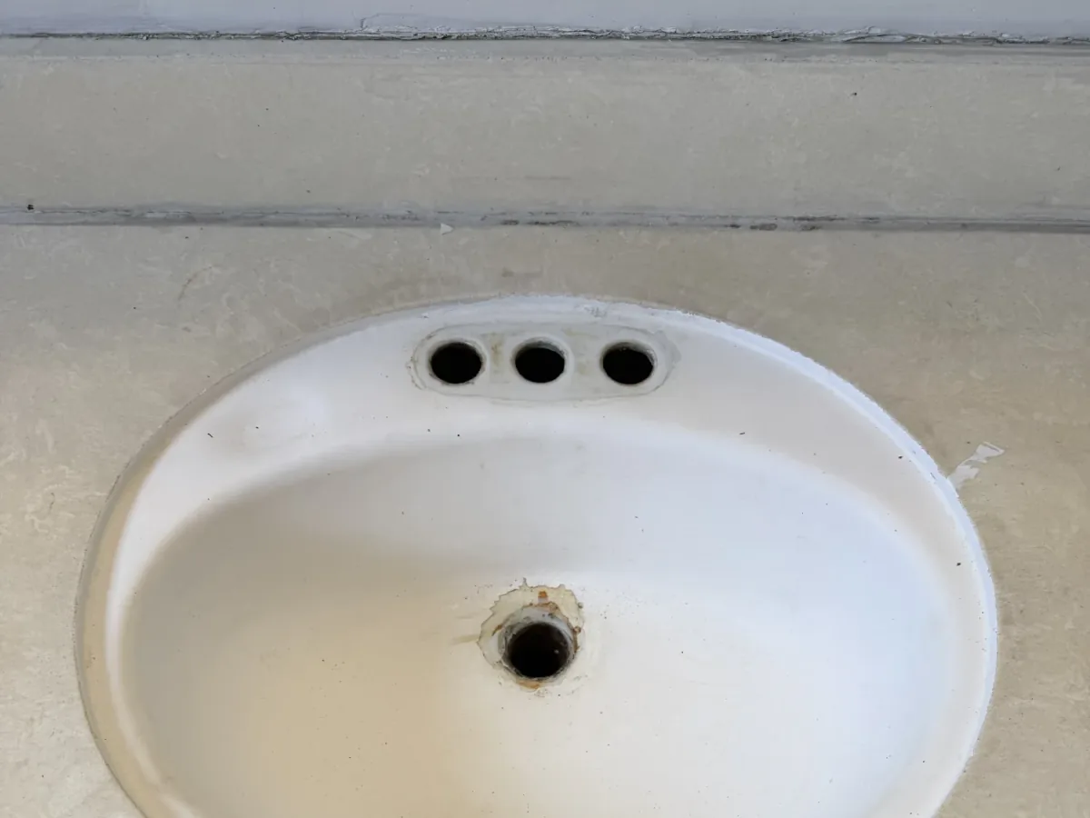 Worn round bathroom vanity sink before refinishing in Los Angeles
