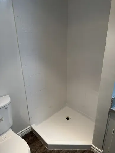 Bright white refinished shower tiles with sealed grout